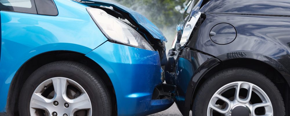 Close Up Of Two Cars Damaged In Road Traffic Accident
