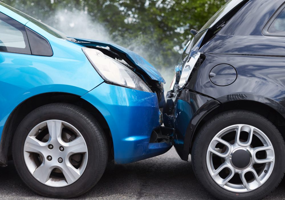 Close Up Of Two Cars Damaged In Road Traffic Accident