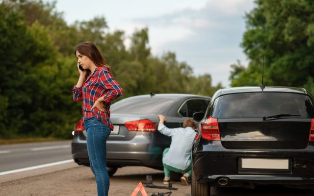 Male and female drivers on road, car accident Male and female drivers on road, car accident. Automobile crash. Broken automobile or damaged vehicle, auto collision on highway